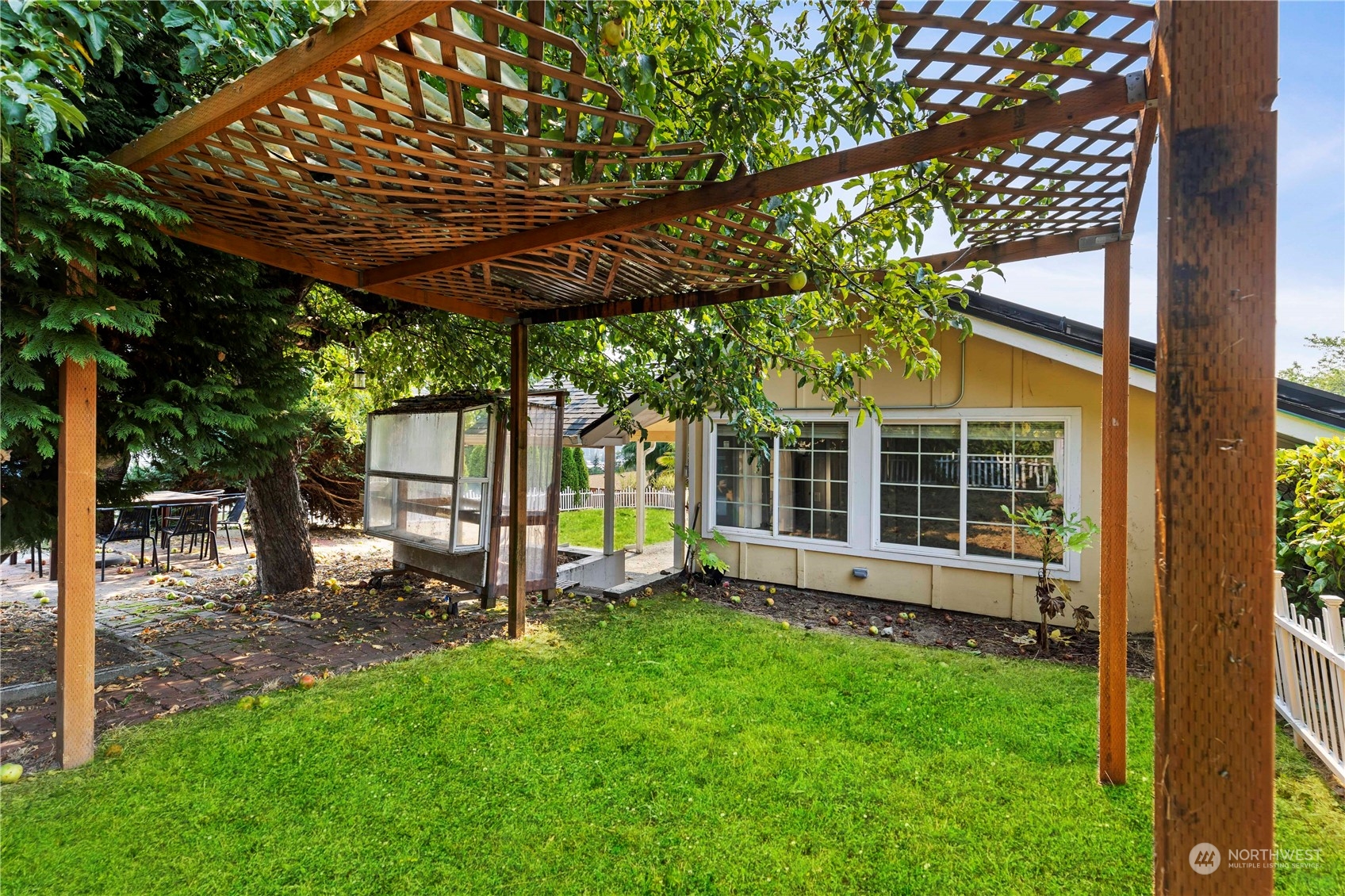 313 Earlington Avenue Southwest Renton, WA 98057 - Photo 34 of 35 a view of a backyard with wooden fence and a large tree