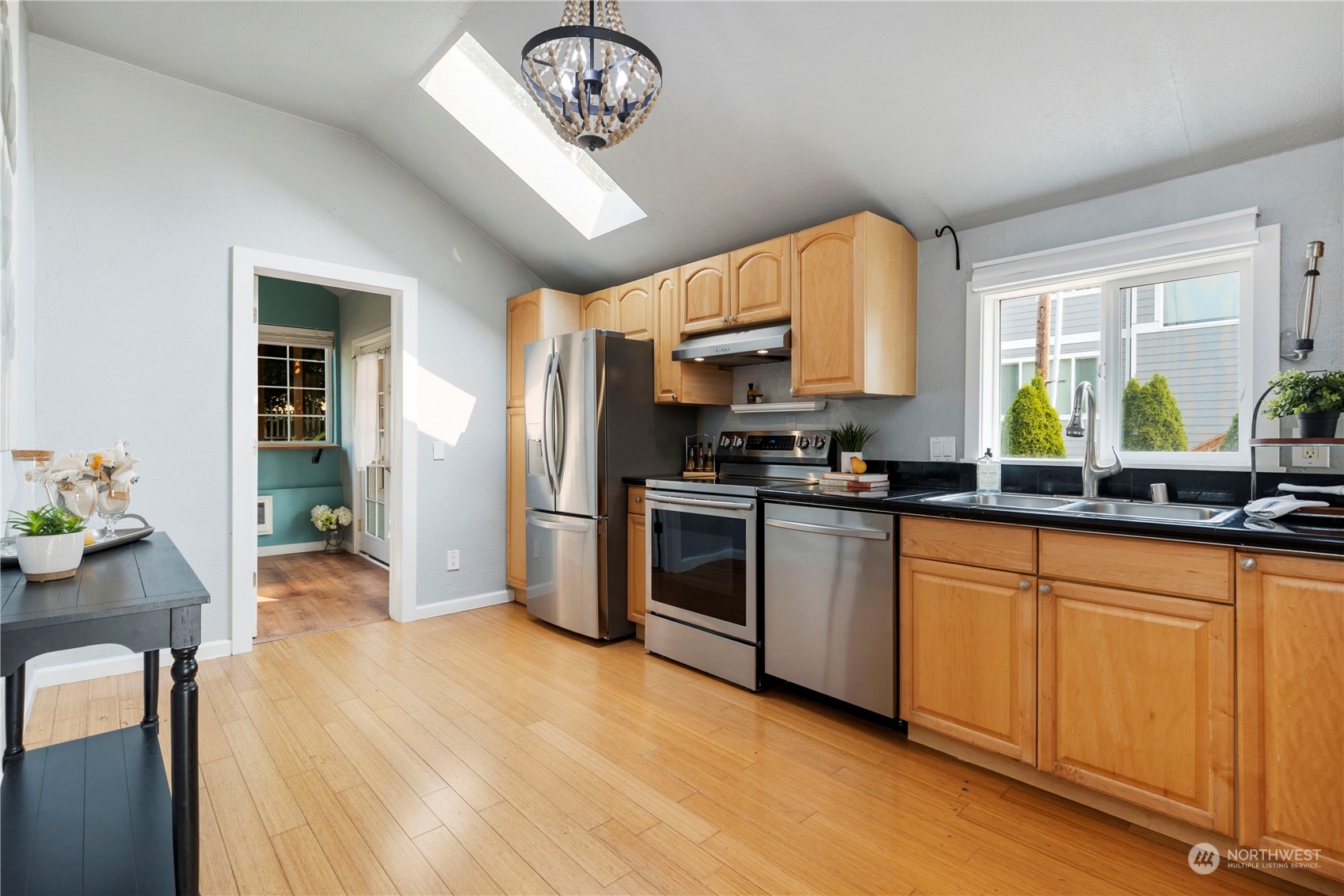 313 Earlington Avenue Southwest Renton, WA 98057 - Photo 7 of 35 a kitchen with stainless steel appliances granite countertop a stove a sink dishwasher and a refrigerator with wooden floor