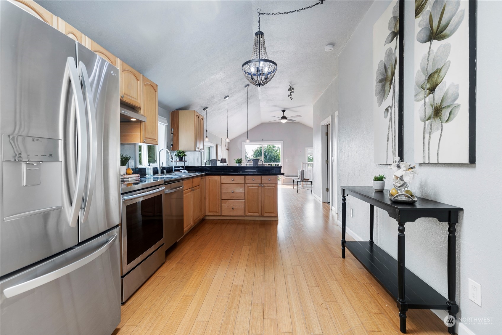 313 Earlington Avenue Southwest Renton, WA 98057 - Photo 8 of 35 a kitchen with stainless steel appliances a refrigerator a sink dishwasher a stove and white cabinets with wooden floor