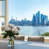 a vase of flowers sitting on a table with wooden floor
