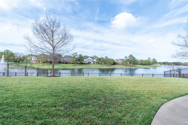 a view of a lake with houses in the back