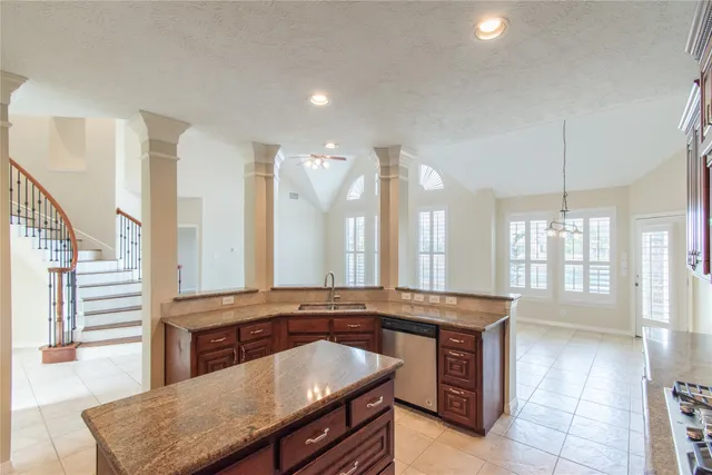 a bathroom with a granite countertop sink a large mirror and a bathtub