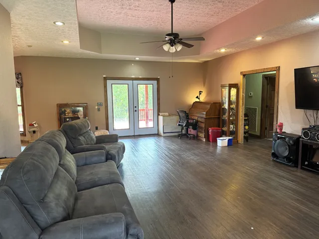 a living room with furniture and wooden floor