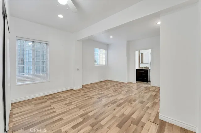 a view of empty room with windows and fireplace