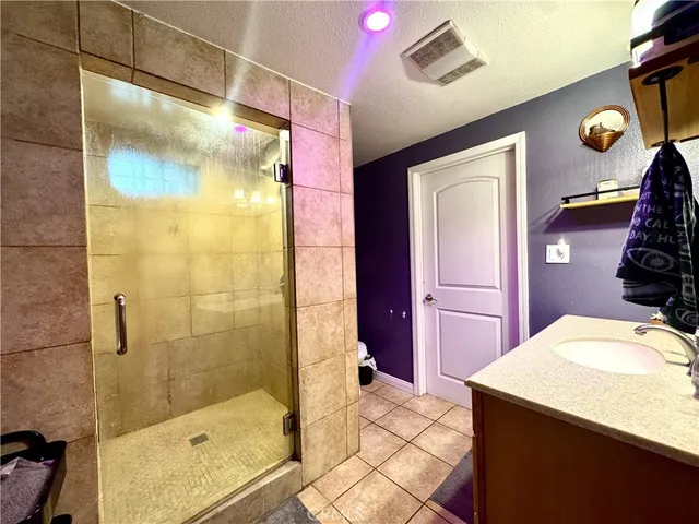 a bathroom with a sink mirror and shower
