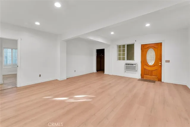 a view of empty room with wooden floor and fireplace