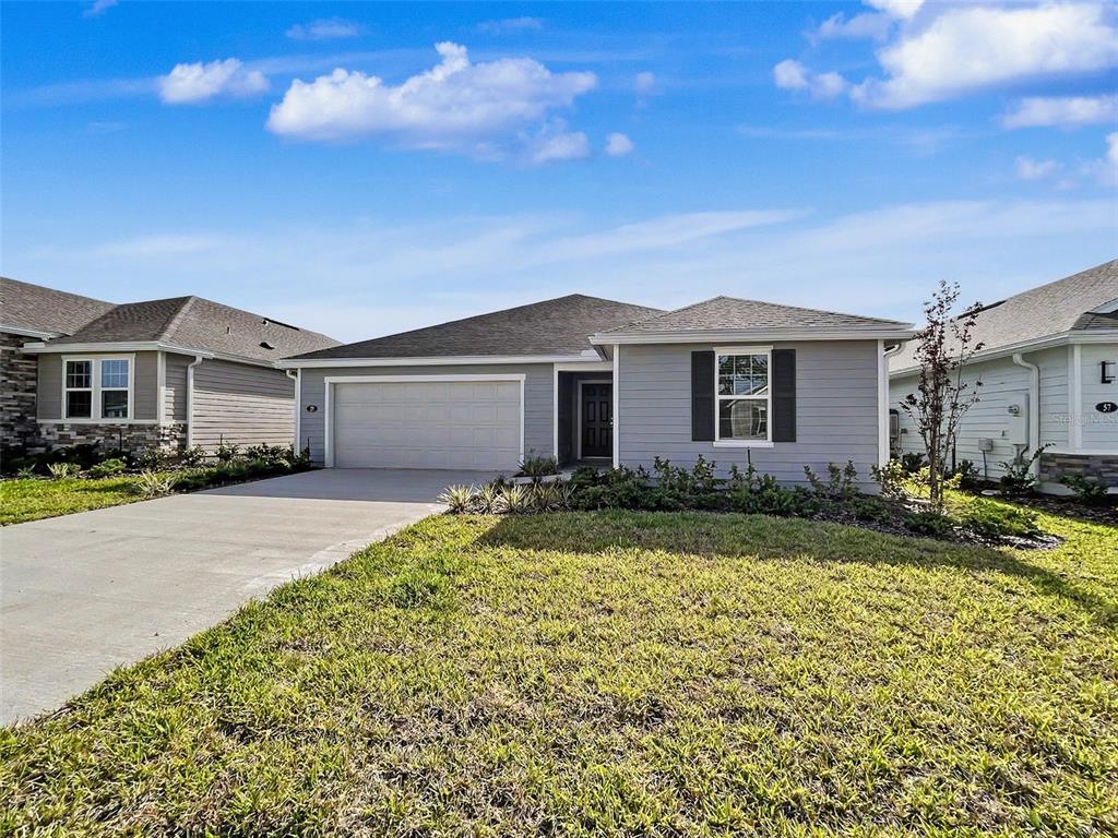 55 Signet Circle Flagler Beach, FL 32136 - Photo 11 of 39 a front view of a house with garden