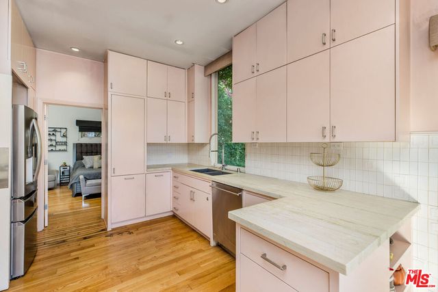 a kitchen with a stove a sink and a refrigerator