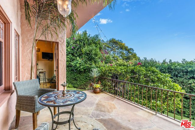a view of a chairs and table in the balcony