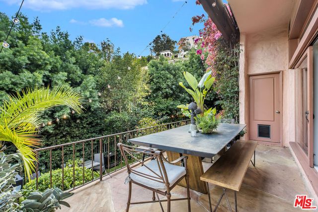 a view of a chairs and table in the balcony