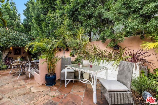 a view of a dining table and chairs in the patio