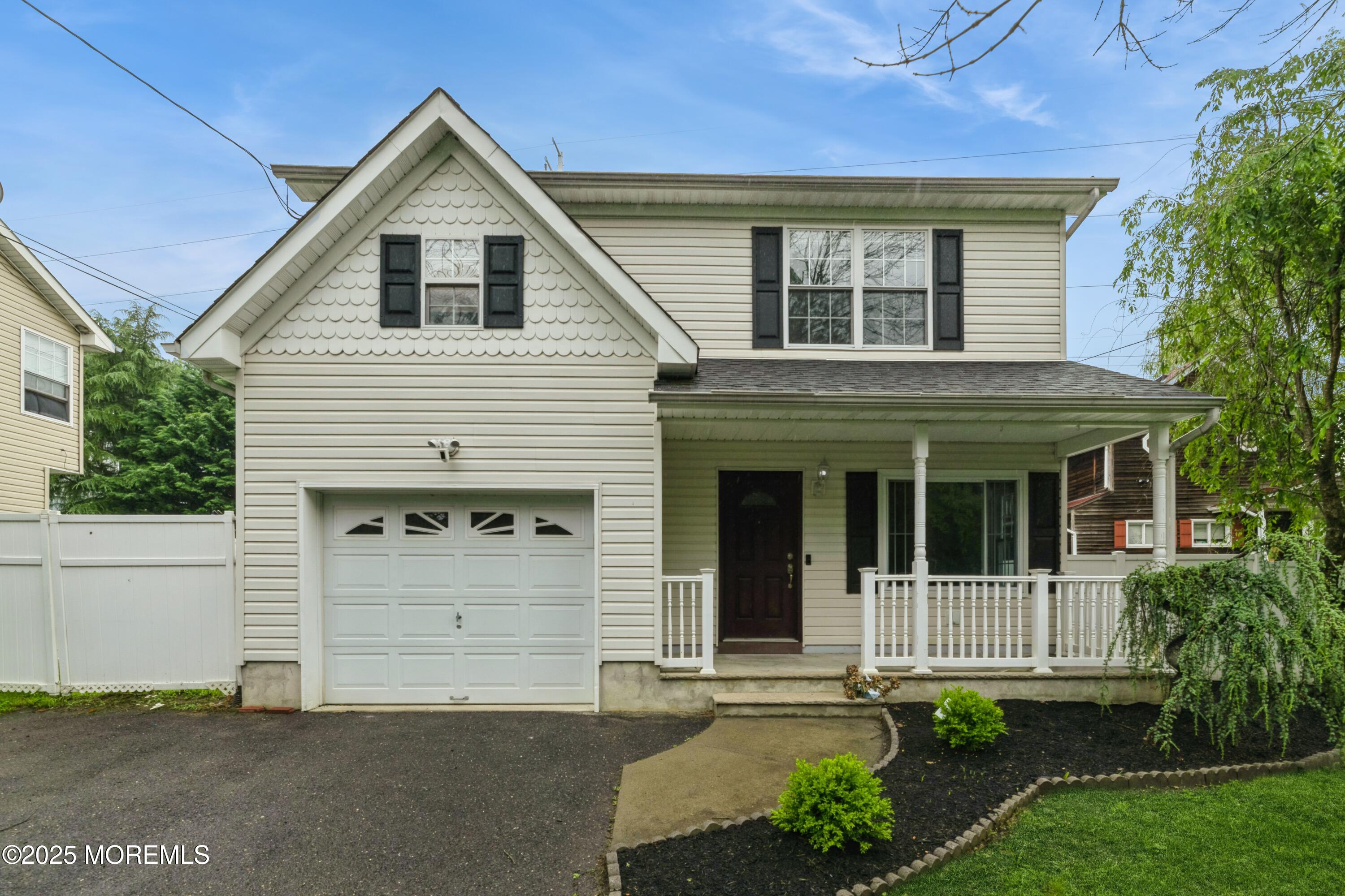 a front view of a house with garage