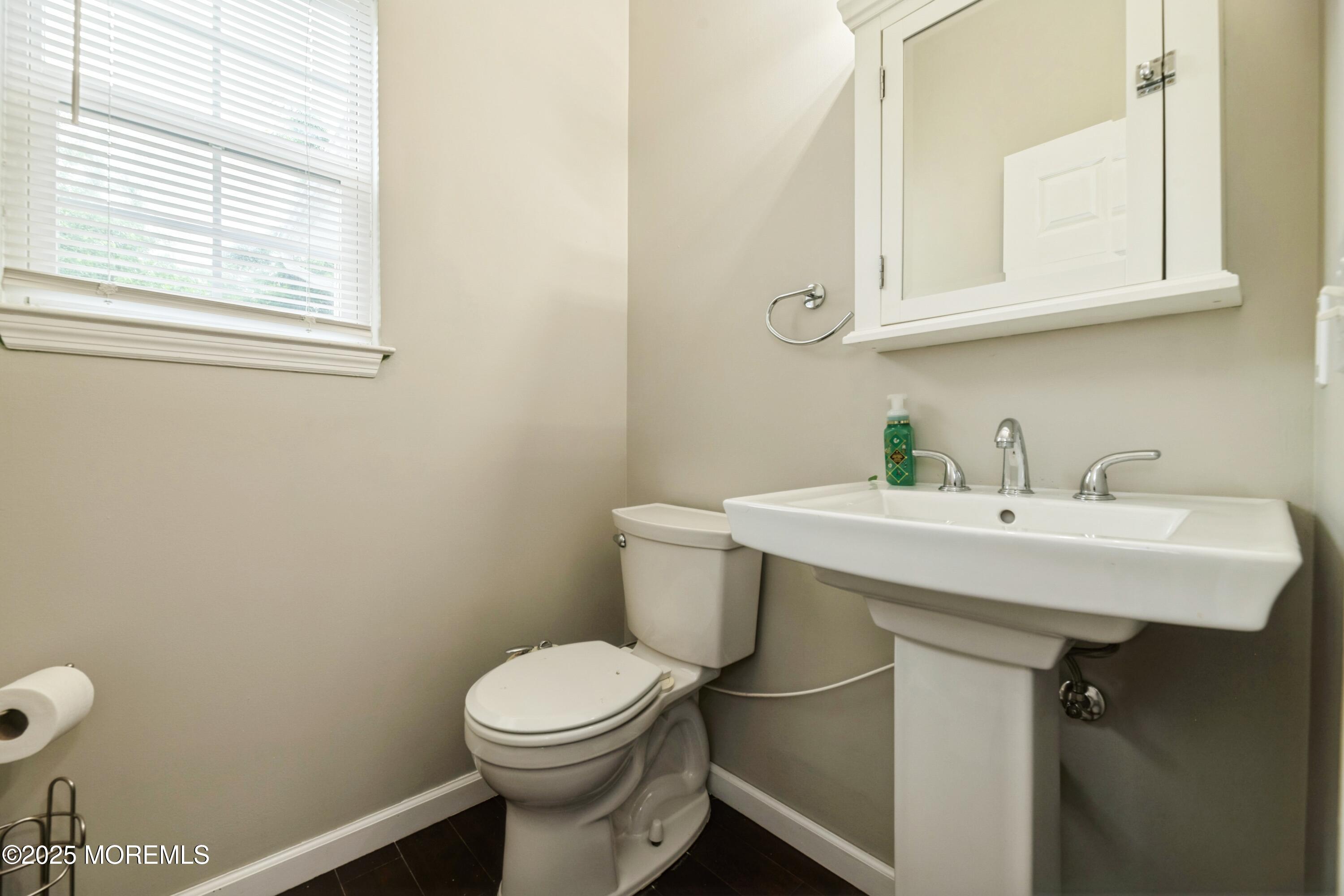 11 Water Street Aberdeen, NJ 07747 - Photo 14 of 25 a bathroom with a sink a toilet and a mirror