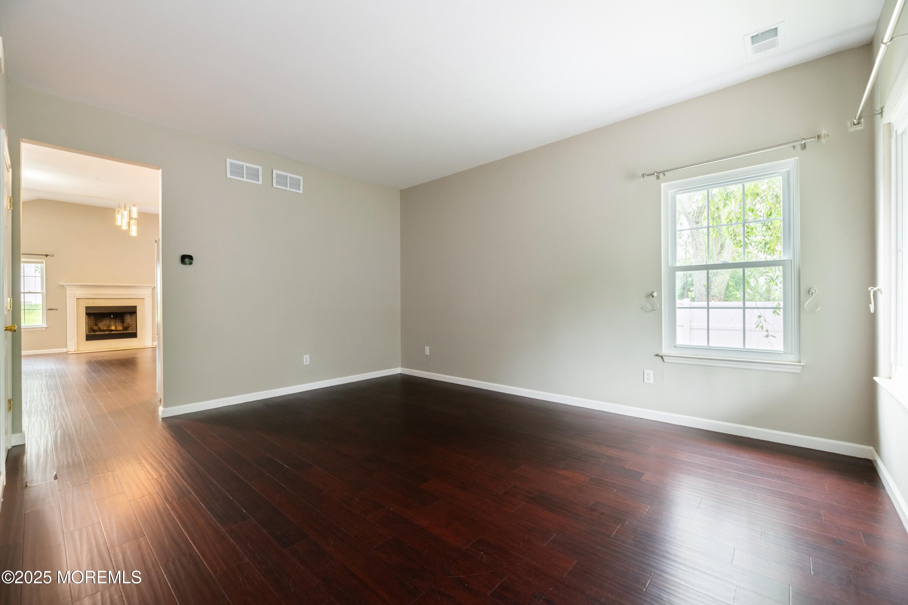 11 Water Street Aberdeen, NJ 07747 - Photo 6 of 25 an empty room with wooden floor and a window