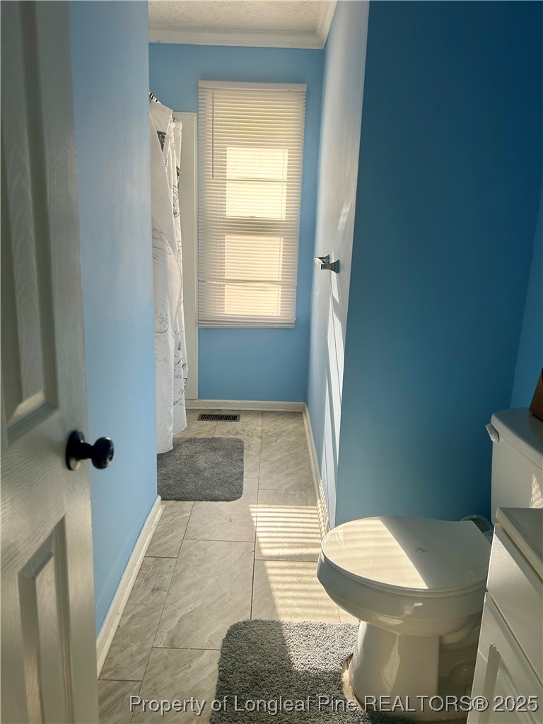 634 Dallas Road Lumberton, NC 28358 - Photo 20 of 27 a bathroom with a sink and toilet
