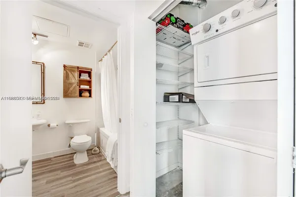 a bathroom with a toilet and a shower curtain
