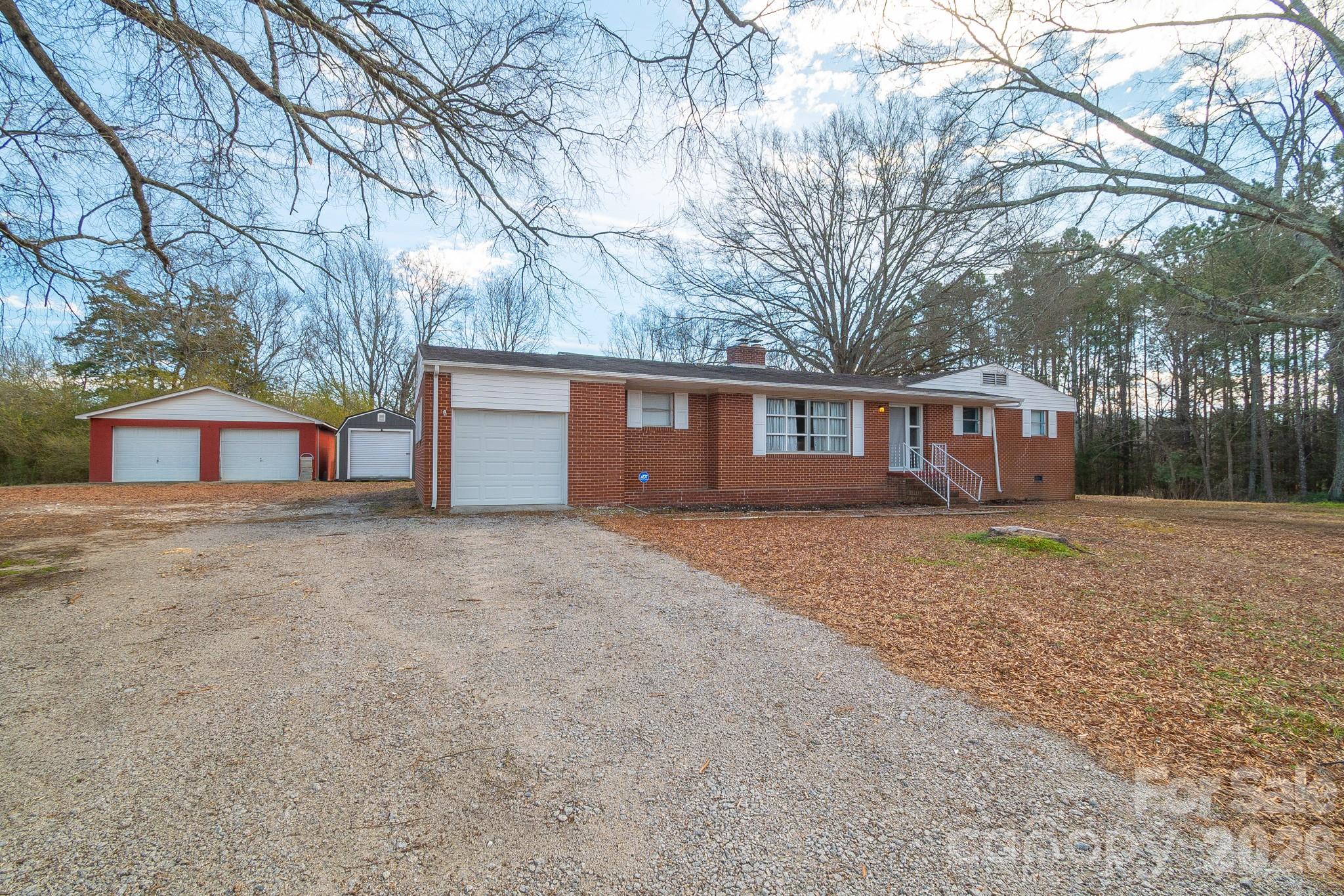 a view of a house with a yard covered in snow
