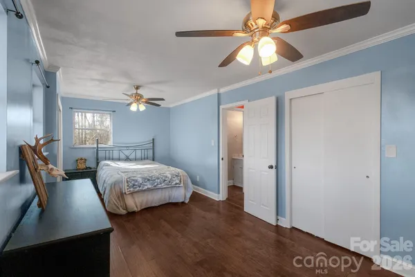a spacious bedroom with a bed and a chandelier