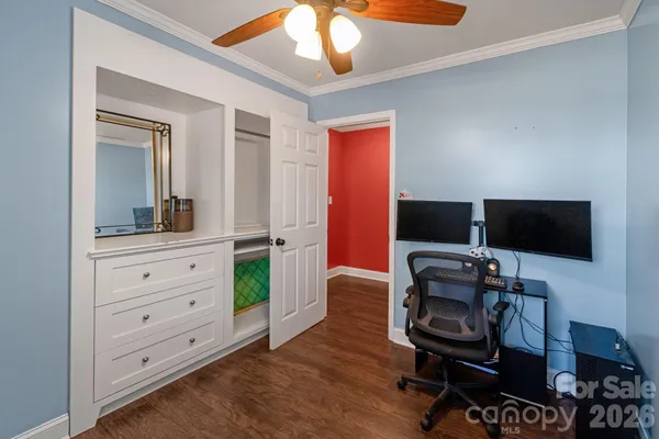 a view of a workspace with furniture and a flat screen tv