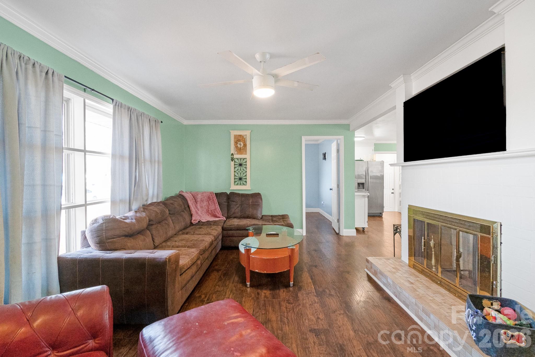1099 South Potter Road Lancaster, SC 29720 - Photo 3 of 41 a living room with furniture a flat screen tv and a fireplace