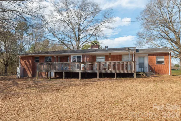 a view of a house with a yard covered in snow