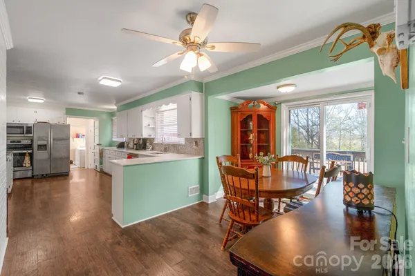 a dining room with furniture entryway and wooden floor
