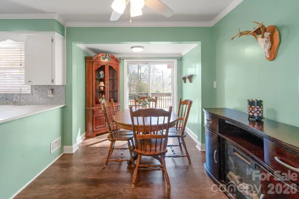 a dining room with furniture a window and wooden floor
