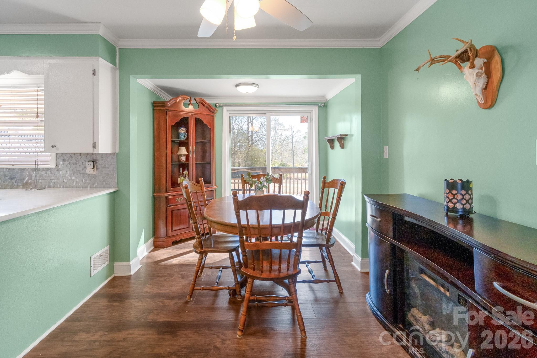 1099 South Potter Road Lancaster, SC 29720 - Photo 7 of 41 a dining room with furniture a window and wooden floor