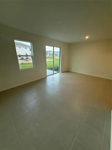 a view of a backyard with plants and large tree