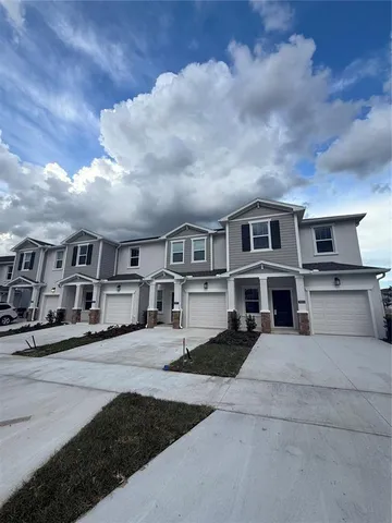 a view of multiple houses with a street