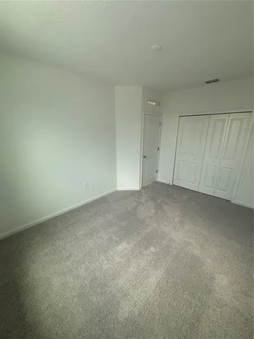 a view of an empty room and a window