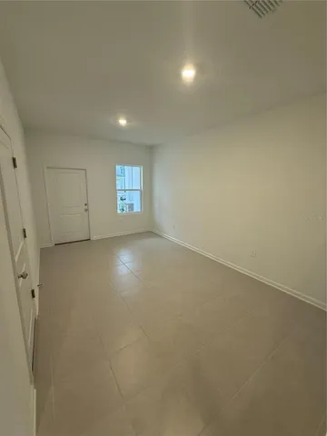 an empty room with windows and entrance