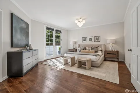 a spacious bedroom with a bed and a large window