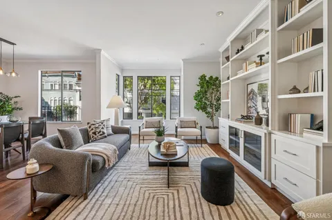 a living room with furniture and a book shelf