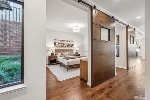 a living room with stainless steel appliances kitchen island granite countertop a refrigerator and a stove