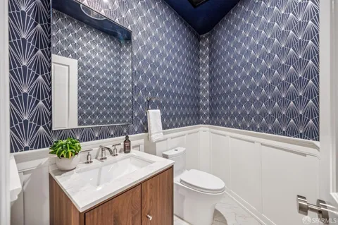 a bathroom with a sink toilet and mirror