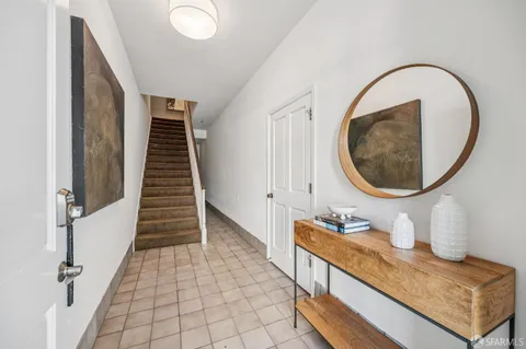 a view of a hallway with entryway wooden floor and front door