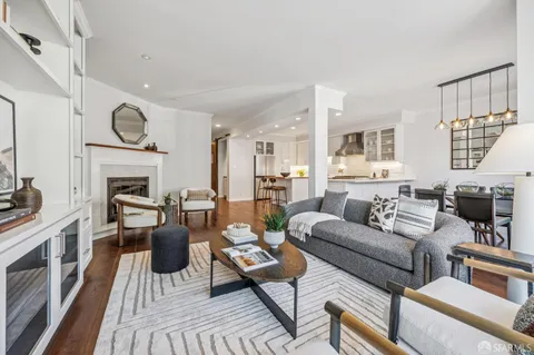 a living room with furniture fireplace and flat screen tv