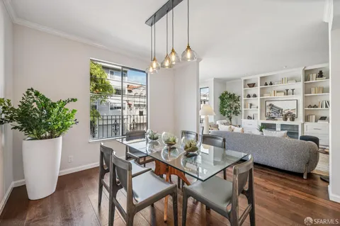 a view of a dining room with furniture window and wooden floor