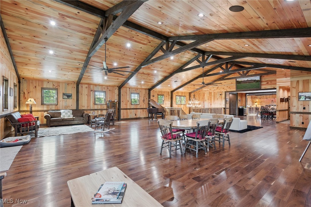 290 Townline Road Aurora, OH 44202 - Photo 10 of 50 Dining area featuring wood finished floors, wood walls, ceiling fan, high vaulted ceiling, and a wood ceiling with exposed beams