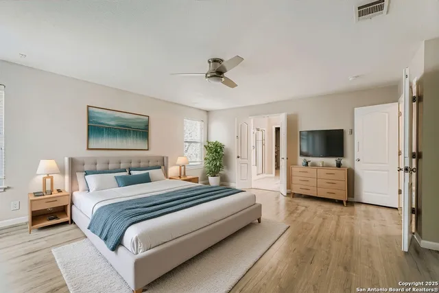 a bedroom with a bed and flat screen tv