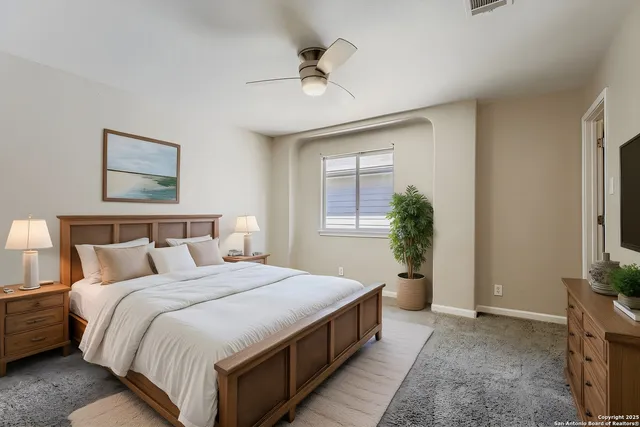 a bedroom with a bed couch and window