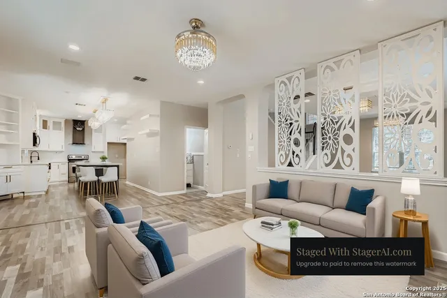 a living room with furniture kitchen view and a large window
