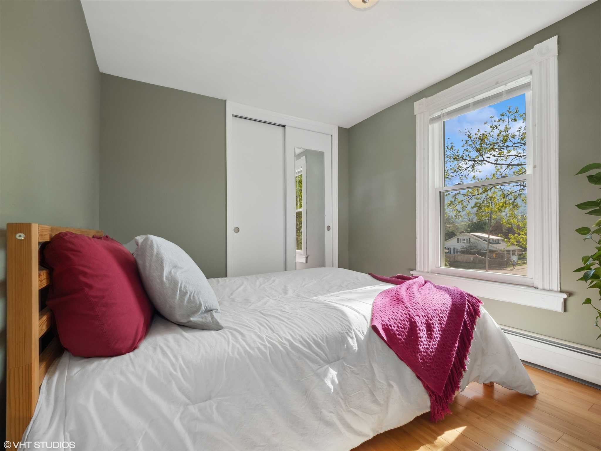 20 John Street Beacon, NY 12508 - Photo 23 of 36 a bed sitting in a bedroom next to a window