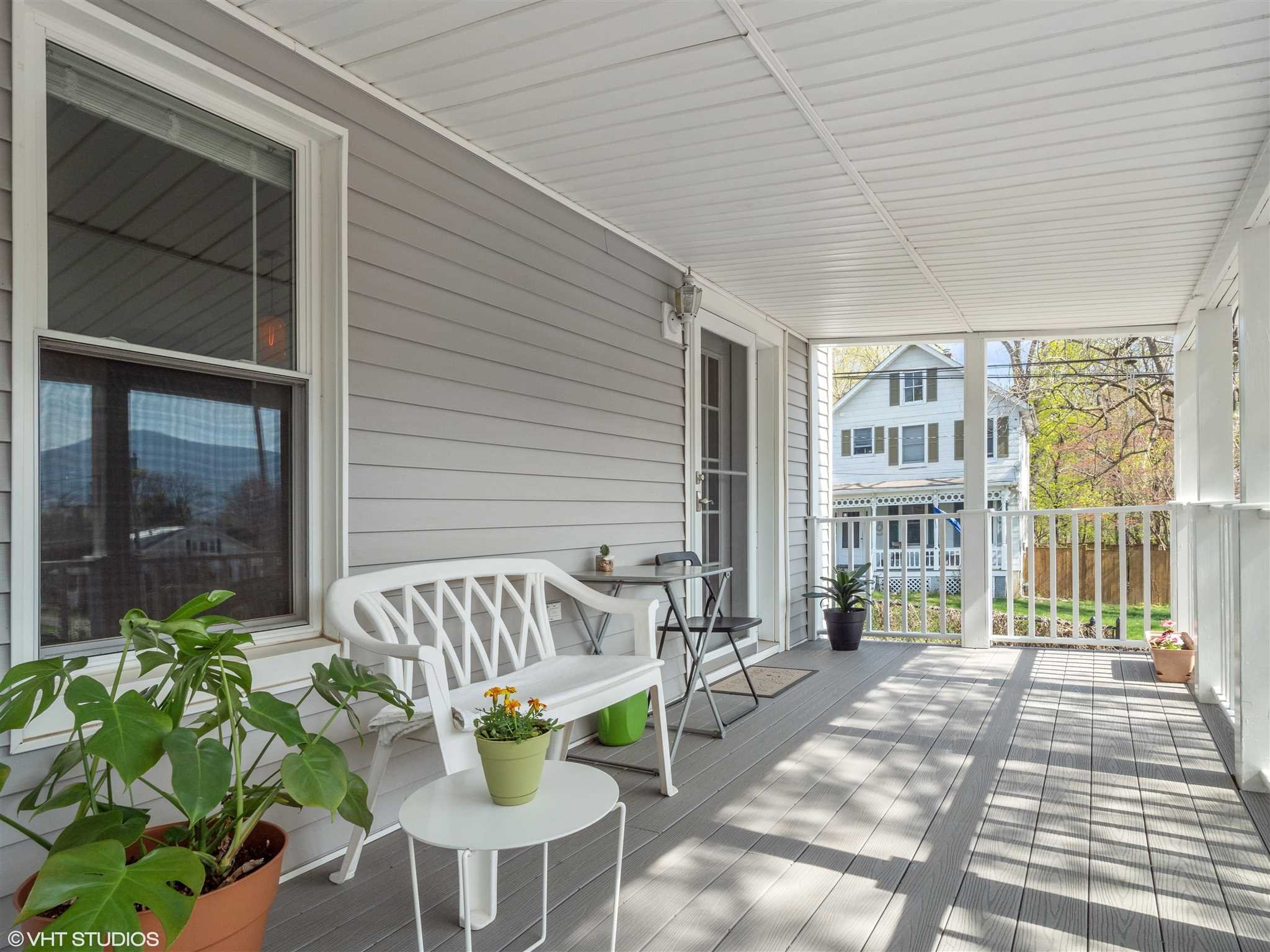 20 John Street Beacon, NY 12508 - Photo 28 of 36 a view of a patio with table and chairs potted plants with wooden floor and fence