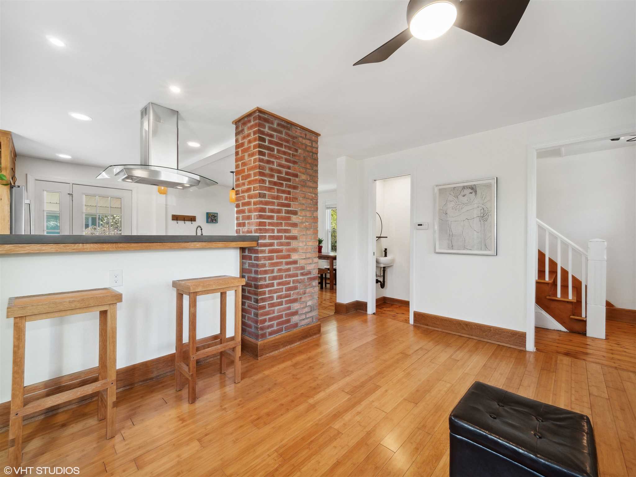 20 John Street Beacon, NY 12508 - Photo 9 of 36 a living room with stainless steel appliances kitchen island granite countertop a refrigerator a stove top oven and a dining table with wooden floor