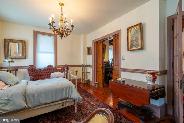 a bedroom with a bed and a chandelier