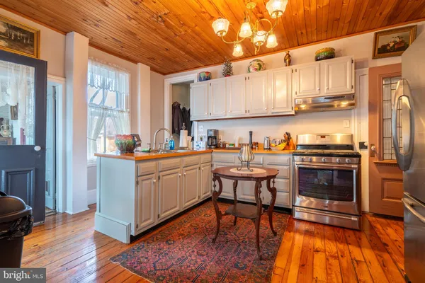 a view of a room with wooden floors and windows