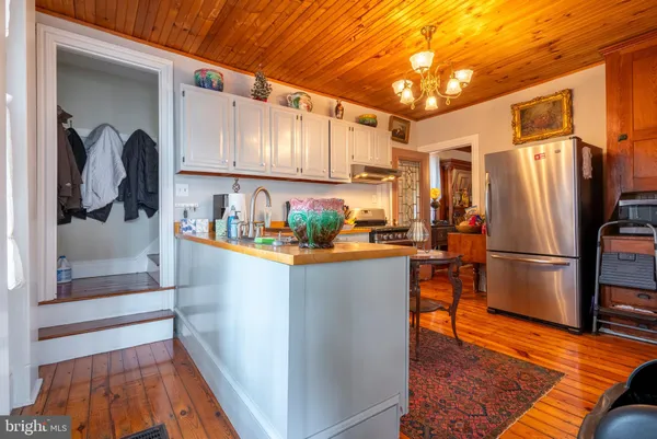 a view of a room with exposed radiator and wooden floor