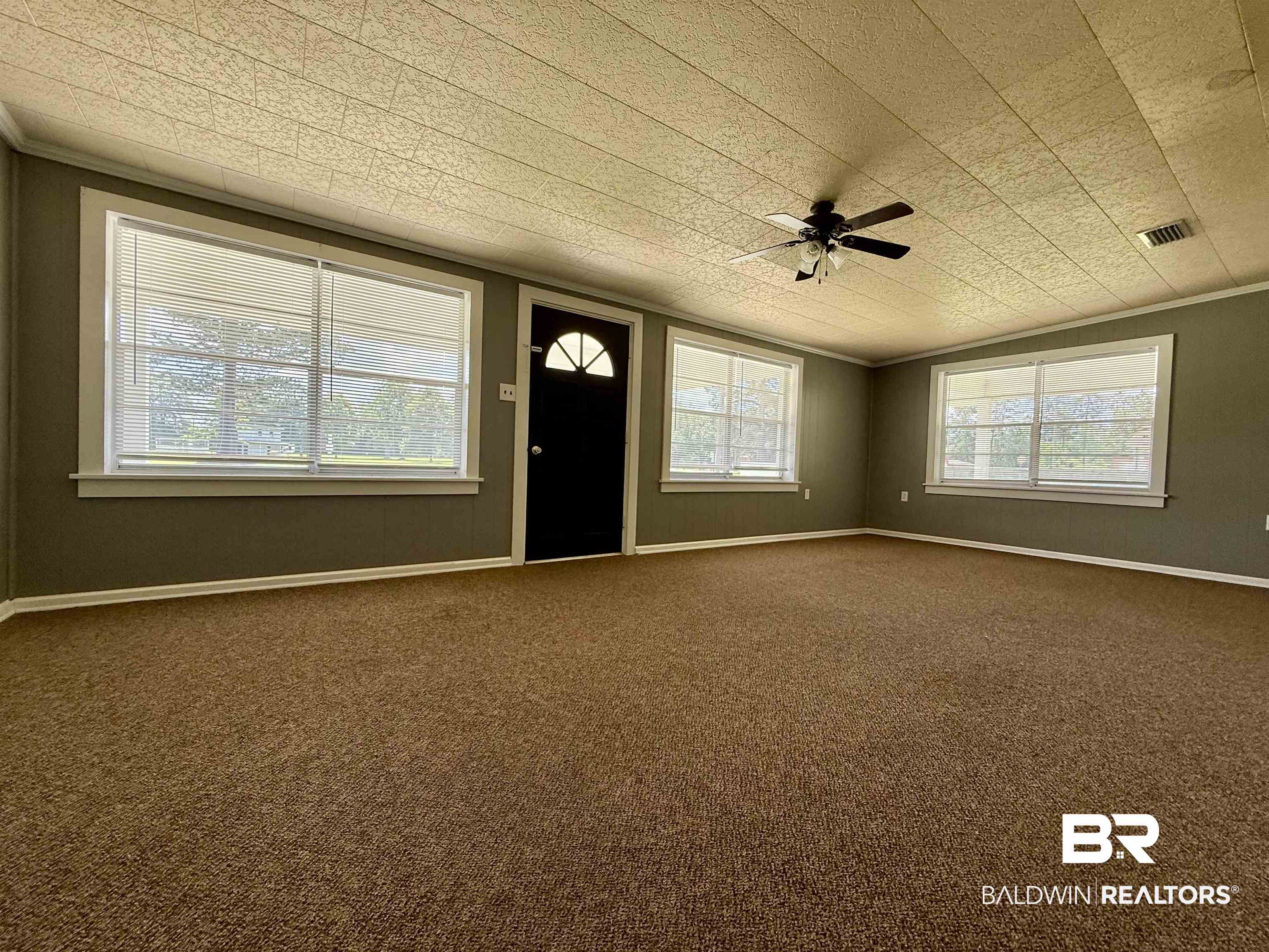 103 Kimberly Street Brewton, AL 36426 - Photo 4 of 18 Entrance foyer featuring crown molding, ceiling fan, healthy amount of natural light, and dark carpet